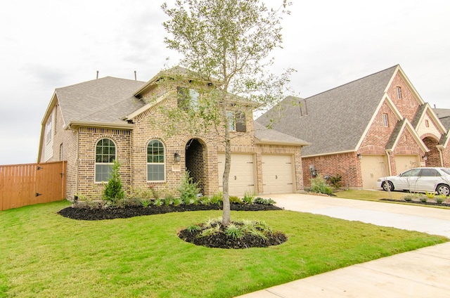 view of front facade featuring an attached garage, brick siding, concrete driveway, and a front yard
