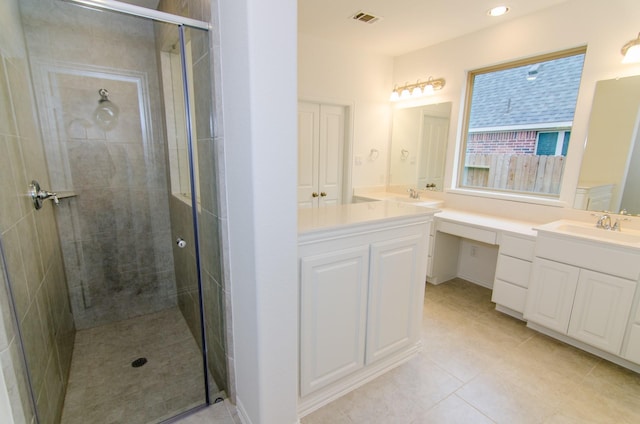 bathroom featuring visible vents, a stall shower, tile patterned floors, and vanity