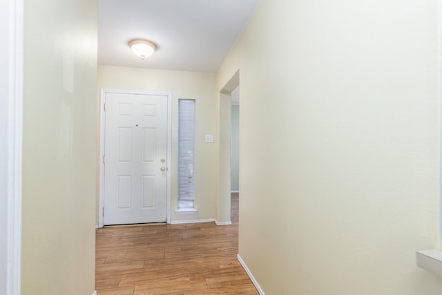 entryway featuring baseboards and light wood-style floors