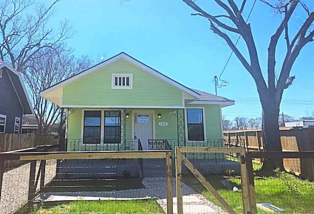 bungalow-style house featuring a fenced front yard, covered porch, and a gate