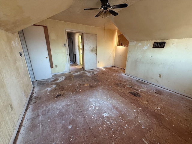 interior space with lofted ceiling and ceiling fan