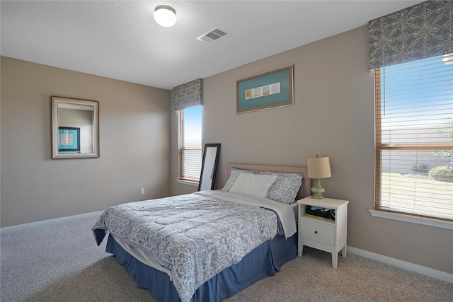 bedroom featuring carpet, visible vents, and baseboards