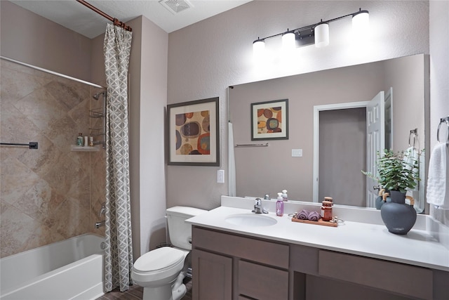 full bath with visible vents, shower / tub combo with curtain, vanity, and toilet