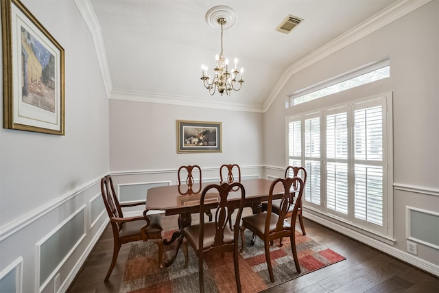 dining room with visible vents, a notable chandelier, crown molding, dark wood-style flooring, and vaulted ceiling