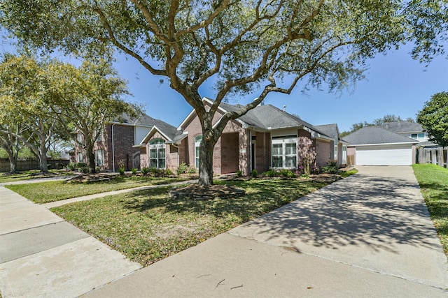 ranch-style house with fence, concrete driveway, a front lawn, an outdoor structure, and brick siding