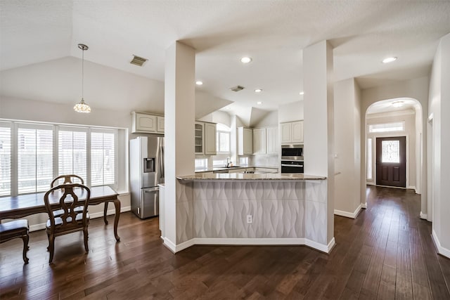 kitchen with visible vents, a sink, arched walkways, stainless steel appliances, and dark wood-style flooring