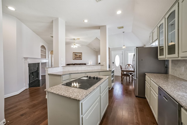 kitchen featuring a center island, stainless steel appliances, dark wood-type flooring, and a ceiling fan