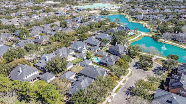 birds eye view of property with a residential view and a water view