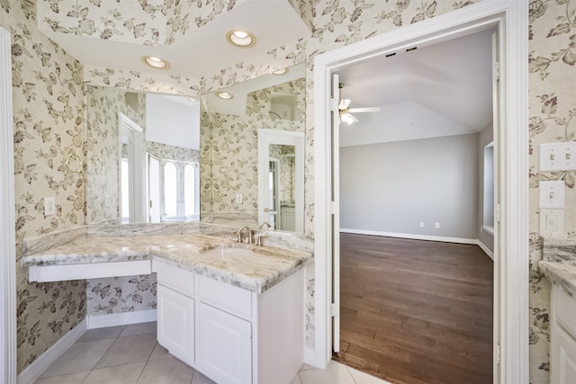 bathroom featuring vanity, baseboards, wallpapered walls, ceiling fan, and tile patterned flooring