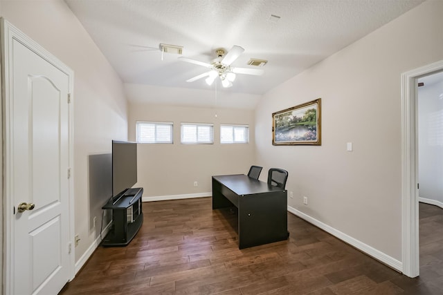 office area featuring a ceiling fan, baseboards, visible vents, dark wood-type flooring, and vaulted ceiling