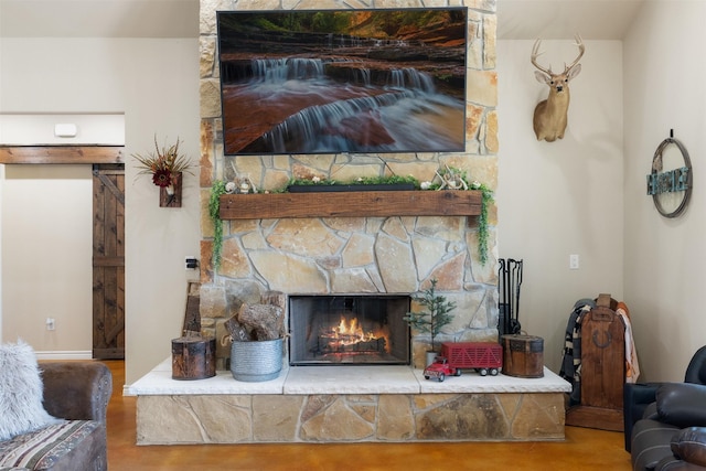 interior details with a stone fireplace, baseboards, and wood finished floors