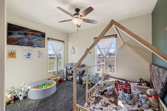 playroom featuring ceiling fan and carpet