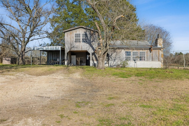 view of front facade featuring an outbuilding and dirt driveway