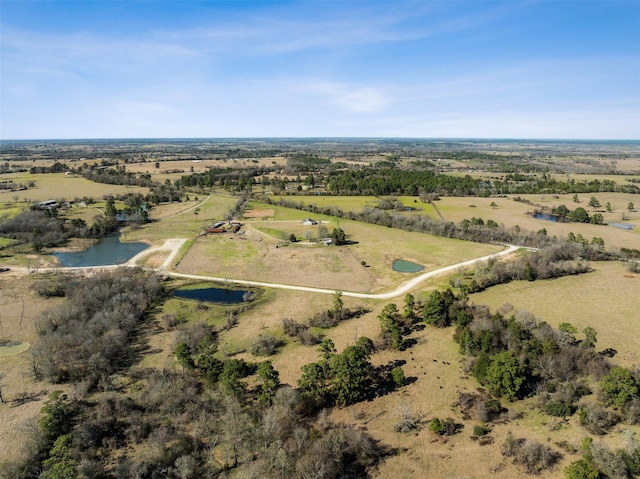 drone / aerial view featuring a water view and a rural view