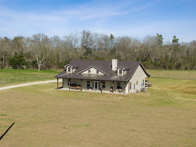 view of front of house with a patio area, fence, a chimney, and a front lawn