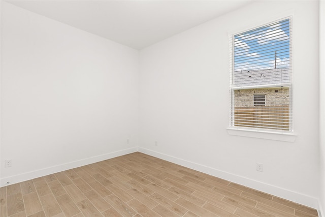 unfurnished room featuring light wood-style flooring and baseboards