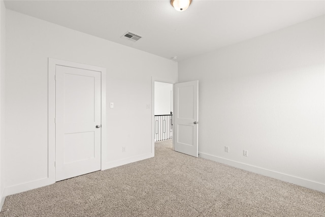 unfurnished bedroom featuring baseboards, visible vents, and carpet flooring