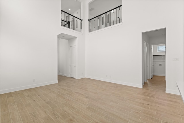 unfurnished room featuring light wood-type flooring and baseboards