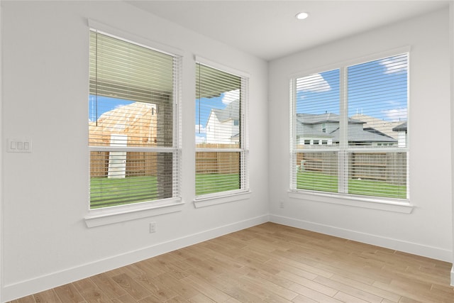 empty room featuring baseboards, recessed lighting, and light wood-style floors