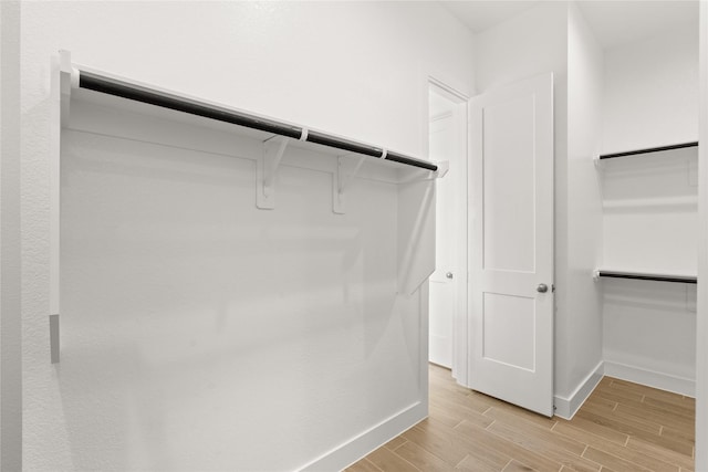 spacious closet featuring wood finish floors