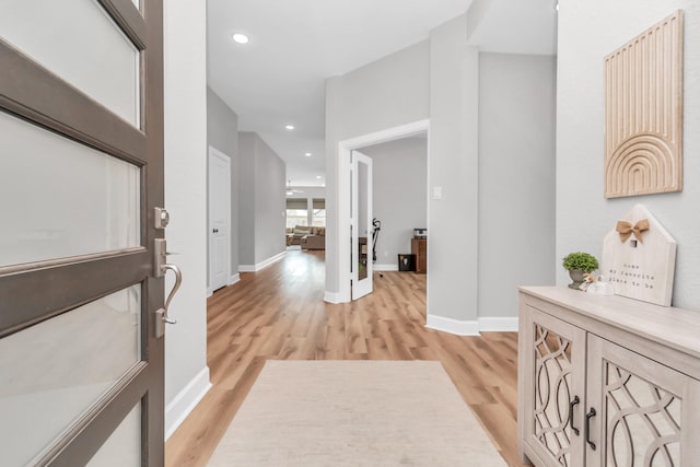 entrance foyer featuring baseboards, light wood-style floors, and recessed lighting