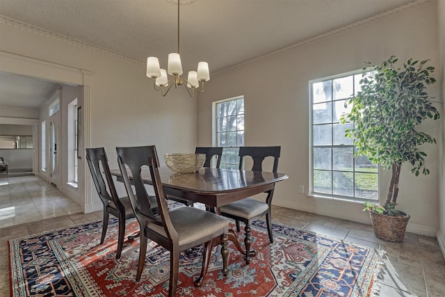 dining room with baseboards, a chandelier, and ornamental molding