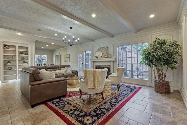 living area with a textured ceiling, ornamental molding, and beamed ceiling