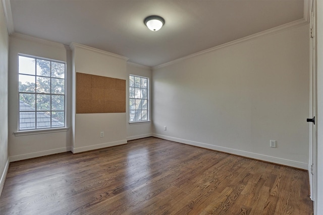 empty room featuring baseboards, dark wood finished floors, and crown molding