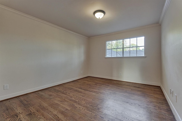 unfurnished room with baseboards, dark wood finished floors, and crown molding