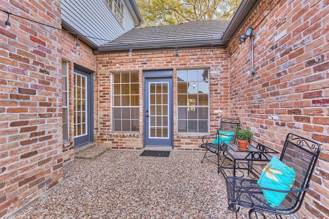 exterior space with a patio and brick siding