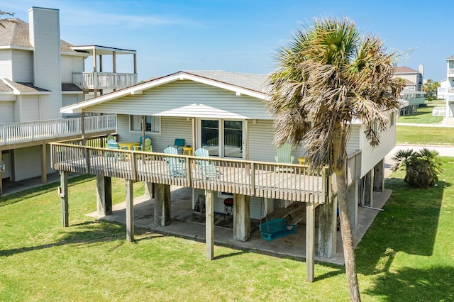 rear view of house featuring a patio area, a deck, and a yard