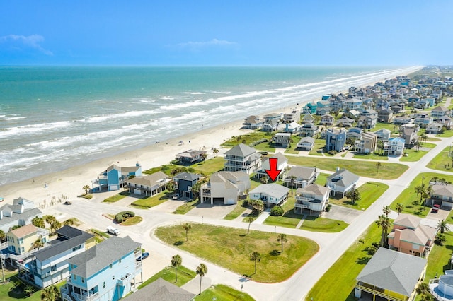 birds eye view of property with a residential view, a water view, and a beach view