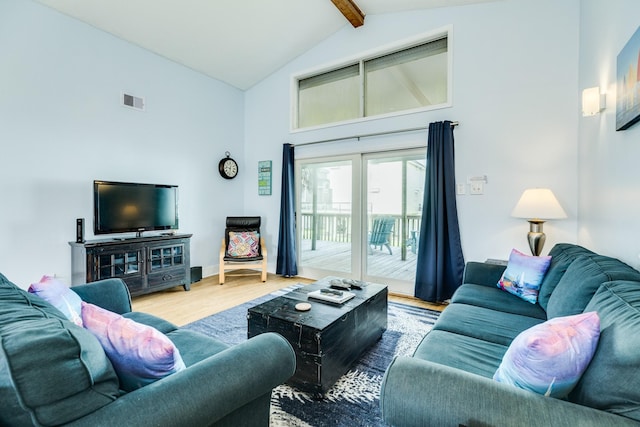 living area featuring high vaulted ceiling, beam ceiling, visible vents, and wood finished floors