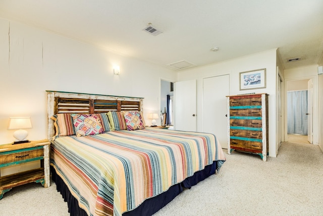 carpeted bedroom featuring attic access and visible vents