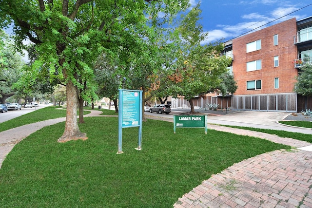 surrounding community featuring fence and a lawn