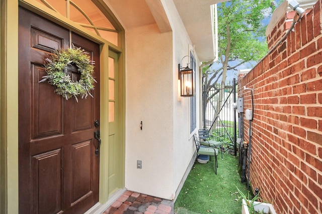 view of exterior entry featuring stucco siding