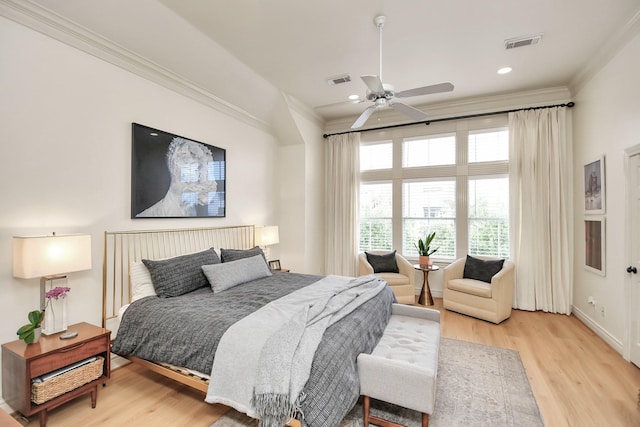 bedroom featuring ornamental molding, visible vents, and light wood-style floors