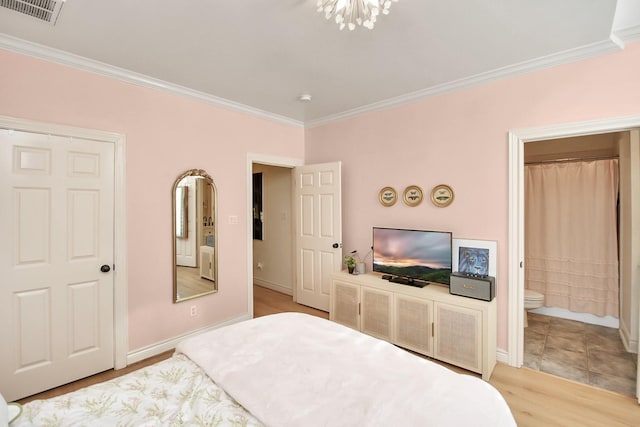 bedroom with baseboards, visible vents, and crown molding