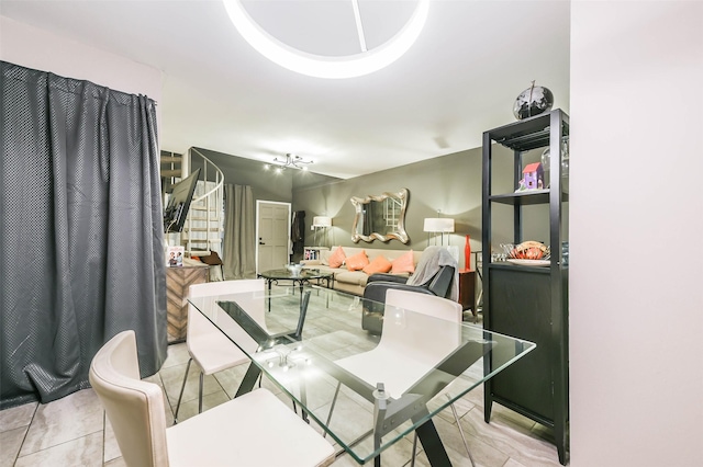 dining area featuring stairway and light tile patterned floors