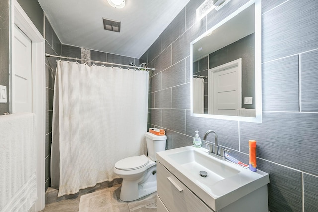 bathroom featuring a shower with shower curtain, visible vents, tile walls, and vanity