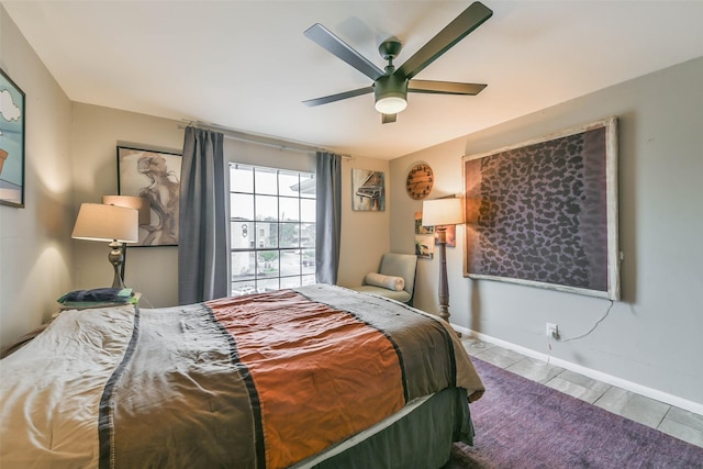 bedroom featuring a ceiling fan and baseboards