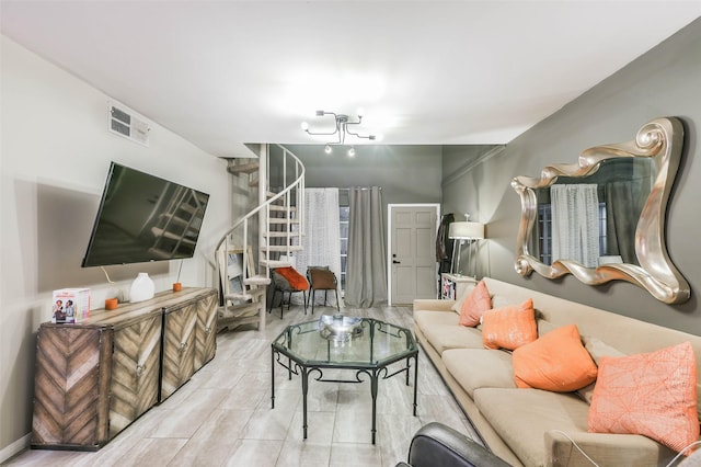 living area featuring visible vents and stairway