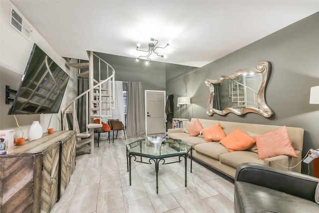 living area featuring visible vents and stairs