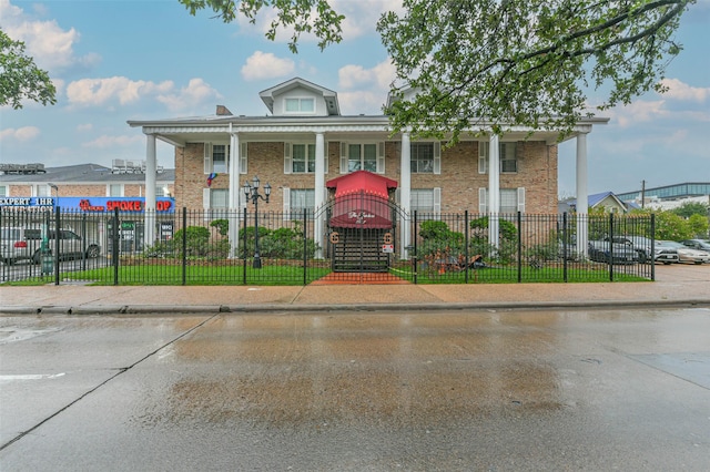 view of building exterior featuring a fenced front yard