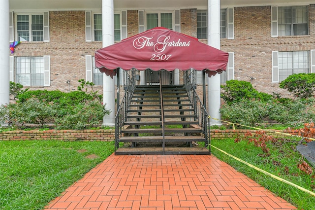 property entrance featuring brick siding