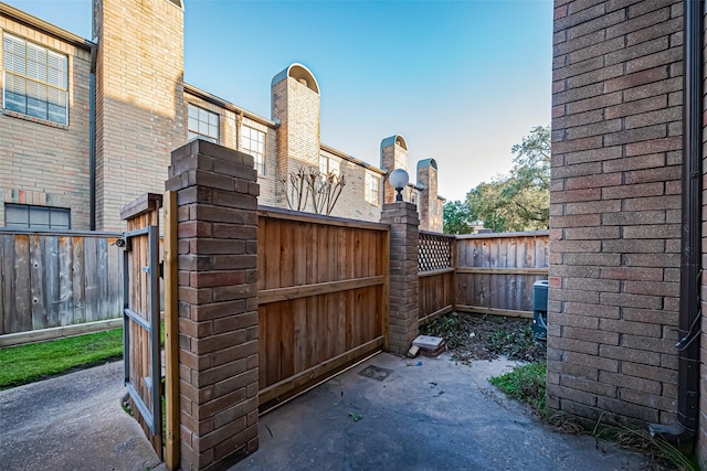 view of gate with a fenced backyard