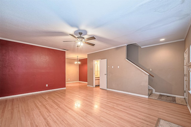 unfurnished living room with baseboards, light wood-style flooring, stairway, ornamental molding, and ceiling fan with notable chandelier