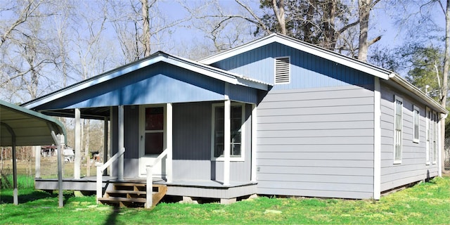 rear view of property with a yard