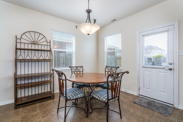 tiled dining area with visible vents and baseboards