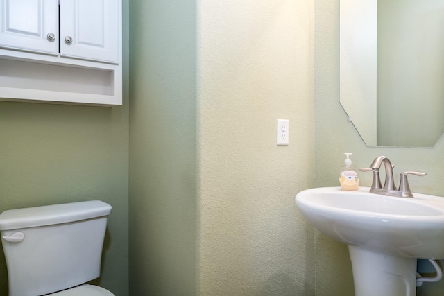 bathroom with toilet and a sink